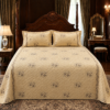 Imported velvet embroidered beige bedsheet set with two matching pillow covers featuring elegant quilted embroidery and luxury bedroom styling.