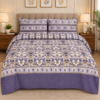 Lavender purple cotton bedsheet set with cream and beige floral patterns and matching pillow covers displayed in a stylish bedroom setting.