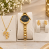 Luxury gold watch and jewelry set featuring a black dial watch, leaf pendant necklace and matching earrings